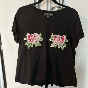 Black top with flower appliqué